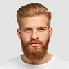 A portrait of a masculine man with a well-groomed ginger beard and styled blond hair, featuring sharp facial features, a neutral expression, and no makeup. He is wearing a simple white crew-neck t-shirt. The lighting is soft and even, highlighting his face against a clean, solid light gray background.